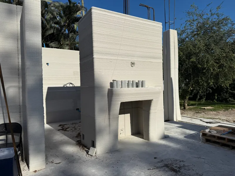 Monolithic printed concrete fireplace wall with integrated hearth.